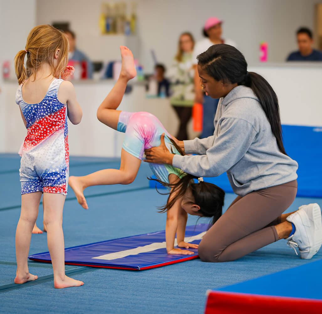 preschool-gymnastics-coach-helping-tumbling (1)